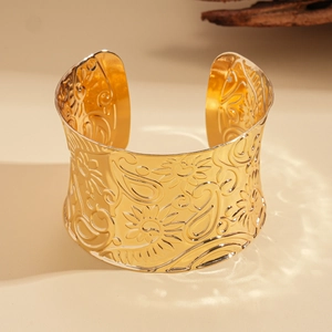 Golden wide open cuff bangle featuring embossed bohemian sunflower and paisley patterns