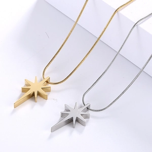Detailed view of lucky star pendants with crystals on gold and silver snake chains