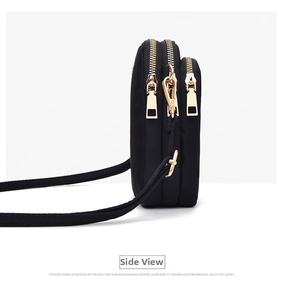 Side view of a compact black crossbody phone bag with three separate zipper layers and gold hardware