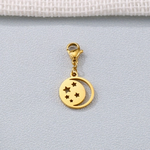 Gold stainless steel moon pendant with star cutouts and lobster clasp on grey fabric