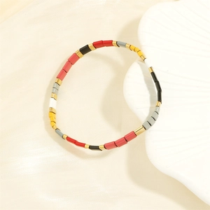 Close-up of bohemian Tila bead bracelet with colorful tile beads and golden accents