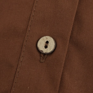 Chic brown poplin shirt with V-neck and detailed view of a premium wooden button texture
