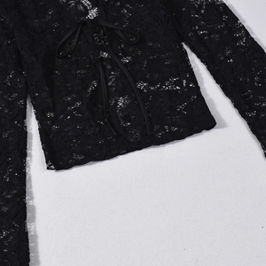 Detailed close-up of black lace top featuring bow tie collar and hollow-out floral patterns