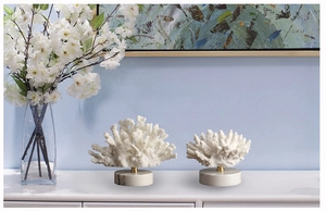 Detail of Nordic resin coral decor with brass stand and white marble base in living room
