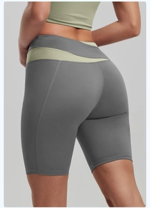 Detail of high-waisted yoga shorts with grey and light green contrast stitching