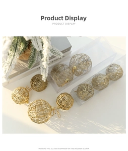 Close-up of golden hollow iron Christmas balls with glitter finish in two sizes