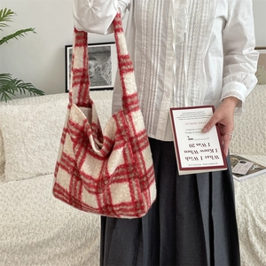 Detail of red and white plaid fuzzy tote bag with premium soft wool texture