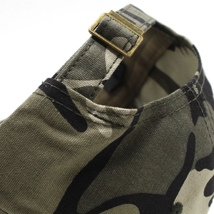 Detail of camouflage military cap featuring an adjustable antique bronze metal buckle back