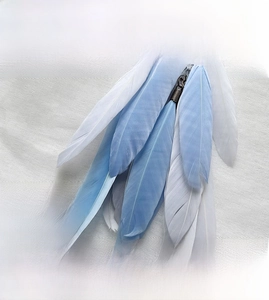 Macro shot of high-quality light blue and white feathers for a car dreamcatcher pendant
