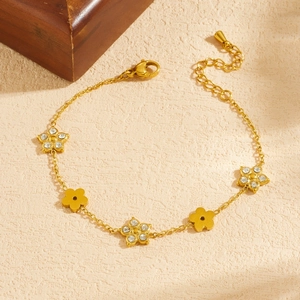 Gold plated stainless steel flower bracelet with sparkling rhinestones and lobster clasp