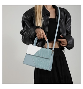 Fashionable blue and white crocodile pattern square bag shown on a model in leather jacket