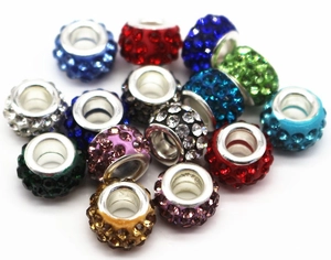 Macro shot of colorful rhinestone beads for DIY jewelry with silver metal rings