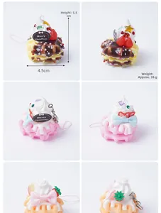 Detailed view of colorful PVC waffle dessert keychains with cream and strawberry accents