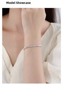 Close-up of golden tennis bracelet with rectangular baguette-cut zircon stones on wrist