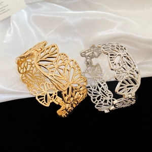 Detailed view of hollow butterfly pattern bracelets in gold and silver metallic finish
