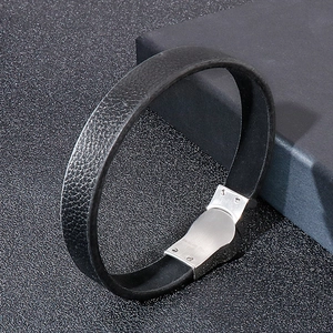 Detail of black braided leather bracelet with brushed silver stainless steel magnetic clasp