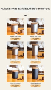 Various sizes of stainless steel coffee canisters with wooden lids on a wooden table