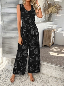 Detail of black floral sleeveless jumpsuit with waist belt and wide-leg trousers design