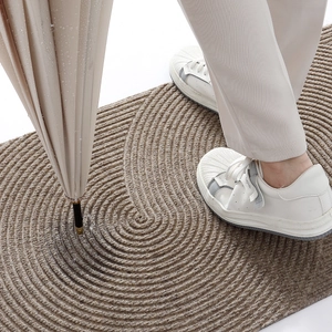 Brown rectangular non-slip door mat with woven texture showing water absorption performance