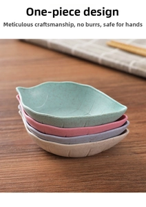 Close-up of leaf-shaped wheat straw seasoning dishes in four colors on a wooden table