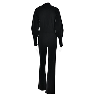 Back view of black long sleeve knitted tracksuit with ribbed waist and flared pants detail
