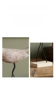 Close-up detail of handcrafted vintage wooden bird sculpture with distressed texture