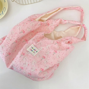 Close-up of pink quilted tote bag with rabbit patterns and sozakka beauté woven label