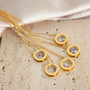 Golden Roman numeral circle necklace with colorful floating zircon crystals set on stone