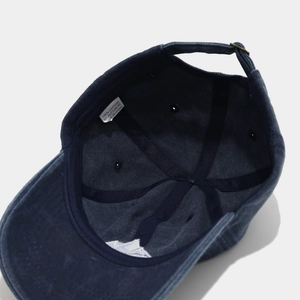 Detailed interior view of navy cotton baseball cap showing stitching and inner sweatband