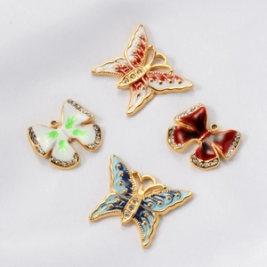 Macro view of butterfly charms with colorful oil drip and sparkling rhinestones