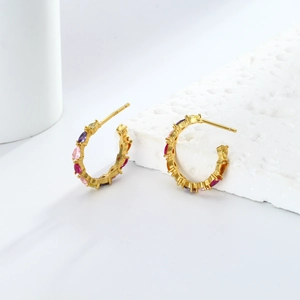 Close-up of gold-plated 925 silver C-shape earrings with vibrant colorful zircons