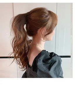 Detail view of large matte beige hair claw clip styled on a model in a half-updo style