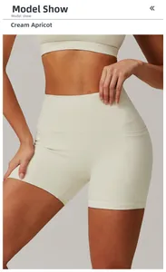 Detail view of high-waisted yoga shorts in Creamy Apricot with functional side pockets