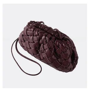 Detailed view of dark burgundy woven leather texture and soft dumpling cloud bag structure