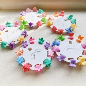 Detail view of 10-piece mini flower hair clips set in colorful candy macaron shades