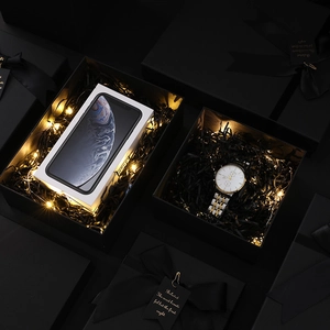 Premium black kraft gift box set with ribbon bow and decorative warm lighting