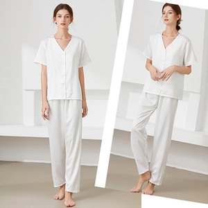 Detail of white silk pajama set featuring short sleeves, V-neck top and long trousers