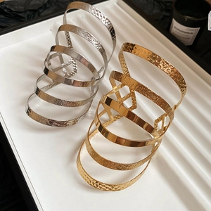 Detailed macro view of gold and silver multilayer metal cuffs with hammered texture