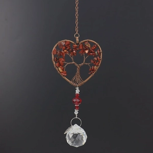 Close-up of bronze wire tree of life suncatcher with red stones and faceted crystal ball