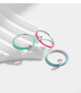 Detailed macro view of three S925 silver rings with colorful enamel and zircon stones