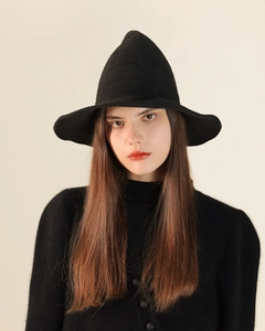 Close-up of a black knitted witch hat showing high-quality texture and pointed design