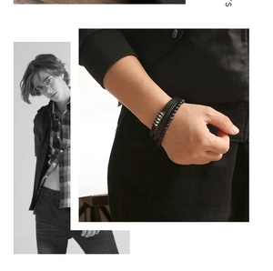 Detail of multi-layer black leather bracelet set with steel rings and matte beads