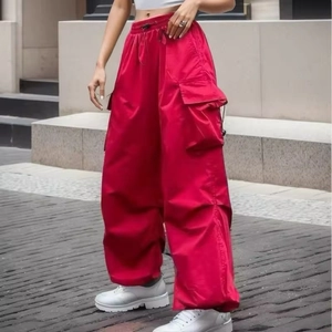Women's baggy red cargo pants with multi-pockets and drawstring cuffs in street style