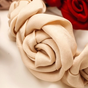 Elegantly crafted champagne satin rose flower headband with realistic fabric texture
