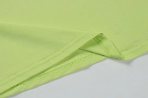 Detail of light green dress hem featuring professional twin-needle stitching finish