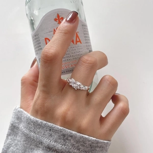 Close-up of S925 sterling silver ring with three sparkling zircon stones on a hand