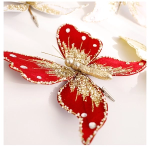 Macro view of red velvet butterfly clip with gold glitter and white beads for Xmas decor