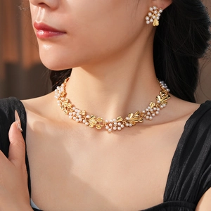 Detail of vintage flower pearl jewelry set featuring golden leaves on a model