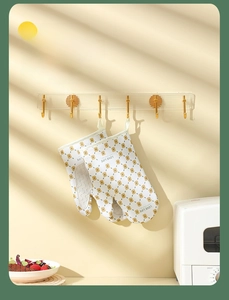 Floral oven mitts with hanging loop displayed in a cozy kitchen setting with warm lighting