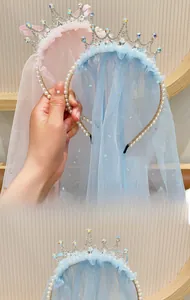 Detail of pink and blue girls crown headband with sequins and pearl decorations